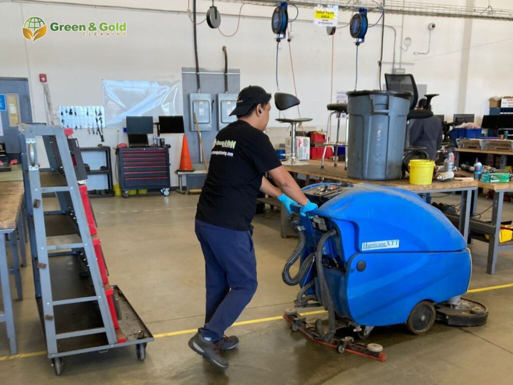 s a person working on machines, maintaining a clean environment